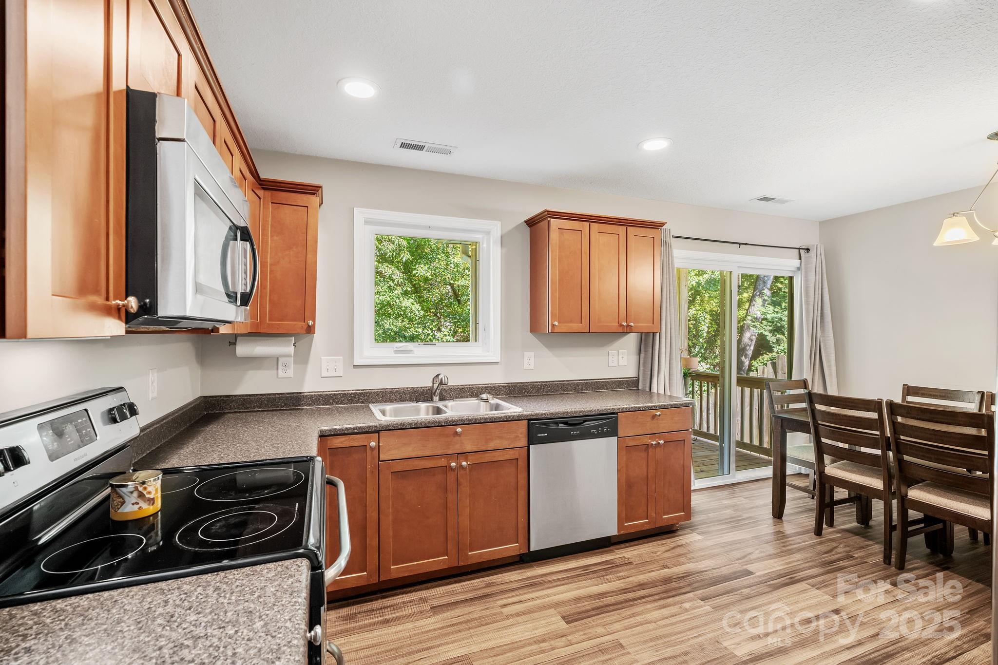 33 English Ivy Road Asheville, NC 28806 - Photo 10 of 27 a kitchen with wooden cabinets and a sink