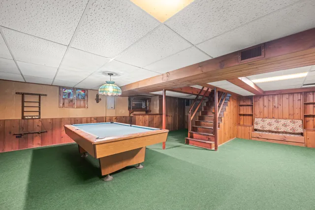 a room with furniture and pool table