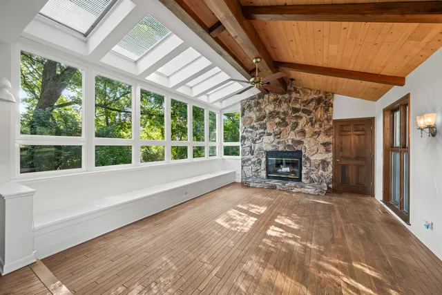 a view of a livingroom with a fireplace and window