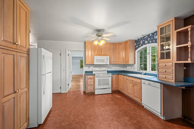 a large kitchen with stainless steel appliances granite countertop a refrigerator and a sink
