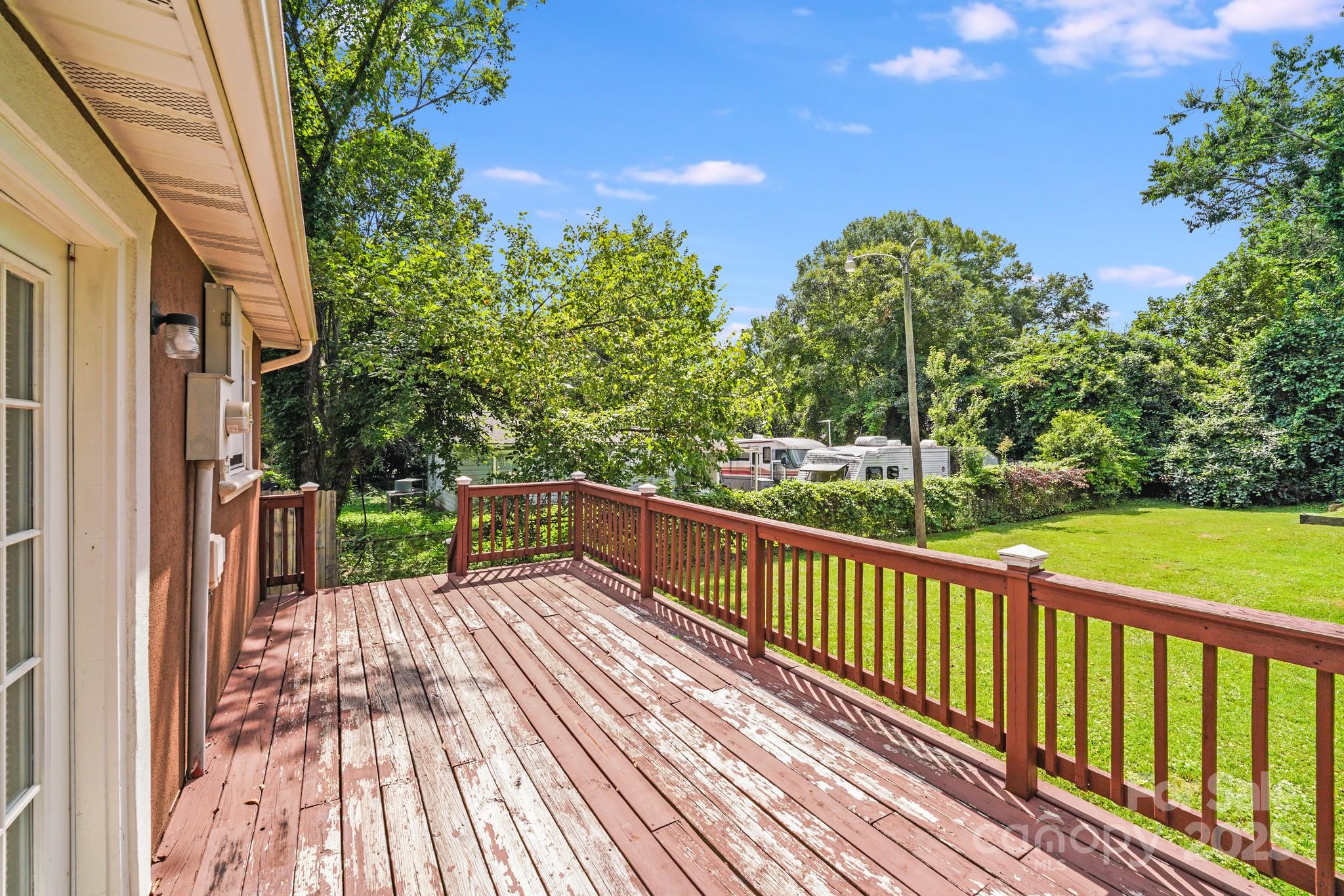8905 Moores Chapel Road Charlotte, NC 28214 - Photo 18 of 22 a view of balcony with wooden floor and fence