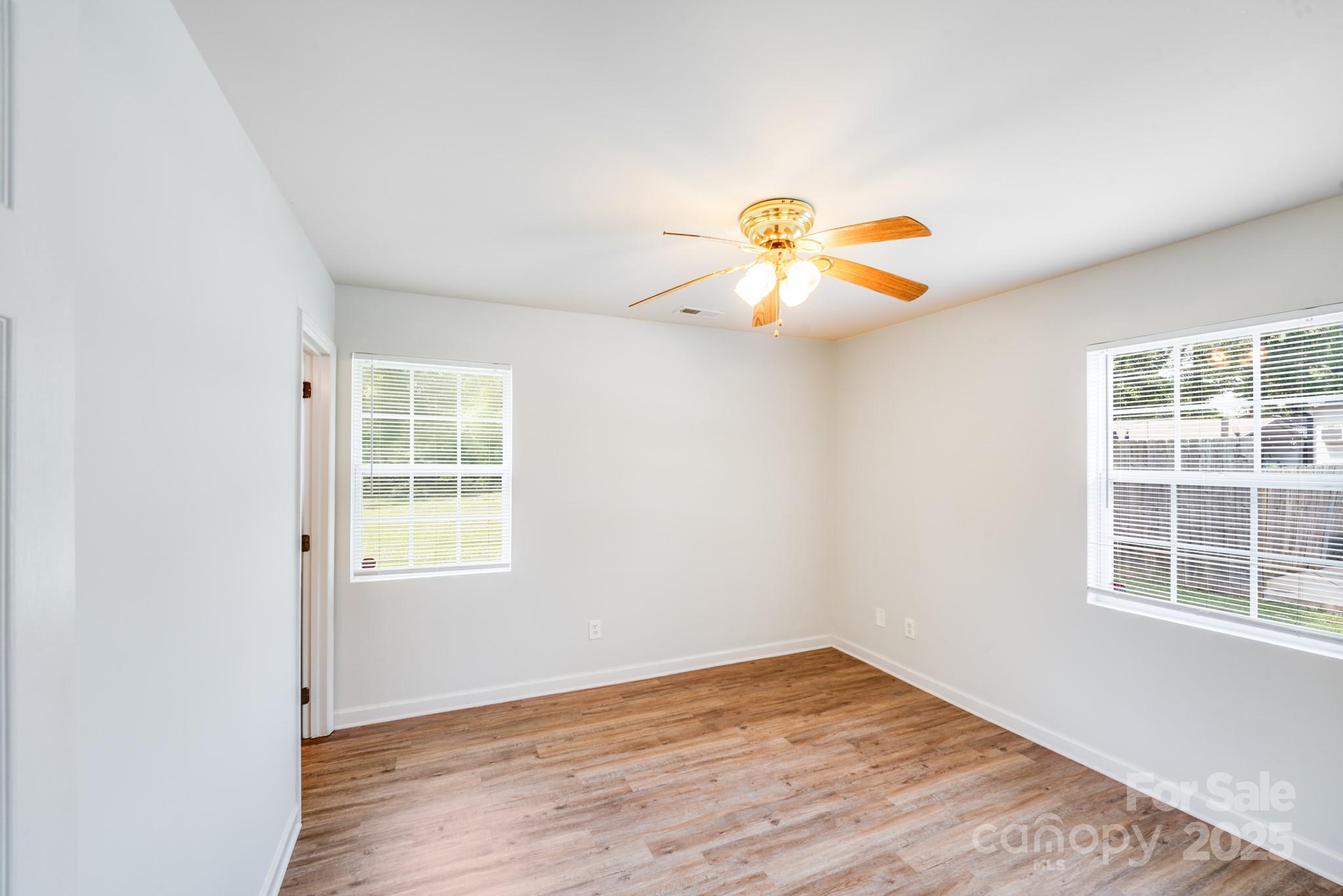 8905 Moores Chapel Road Charlotte, NC 28214 - Photo 5 of 22 an empty room with windows and flower pot