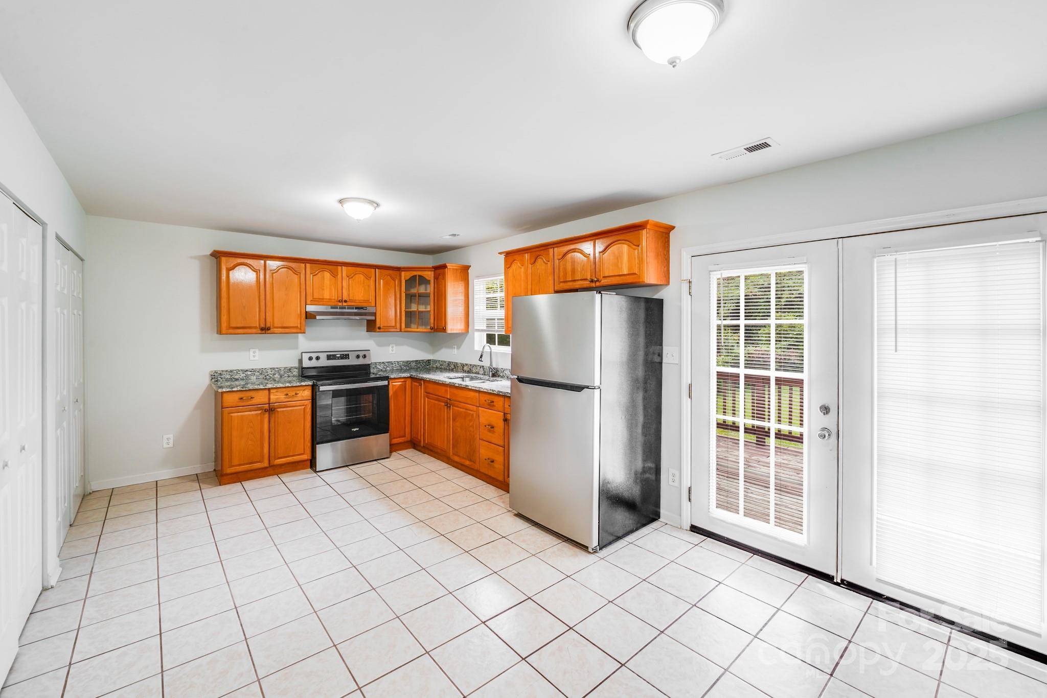 8905 Moores Chapel Road Charlotte, NC 28214 - Photo 8 of 22 a kitchen with stainless steel appliances granite countertop a refrigerator a sink a stove top oven and cabinets