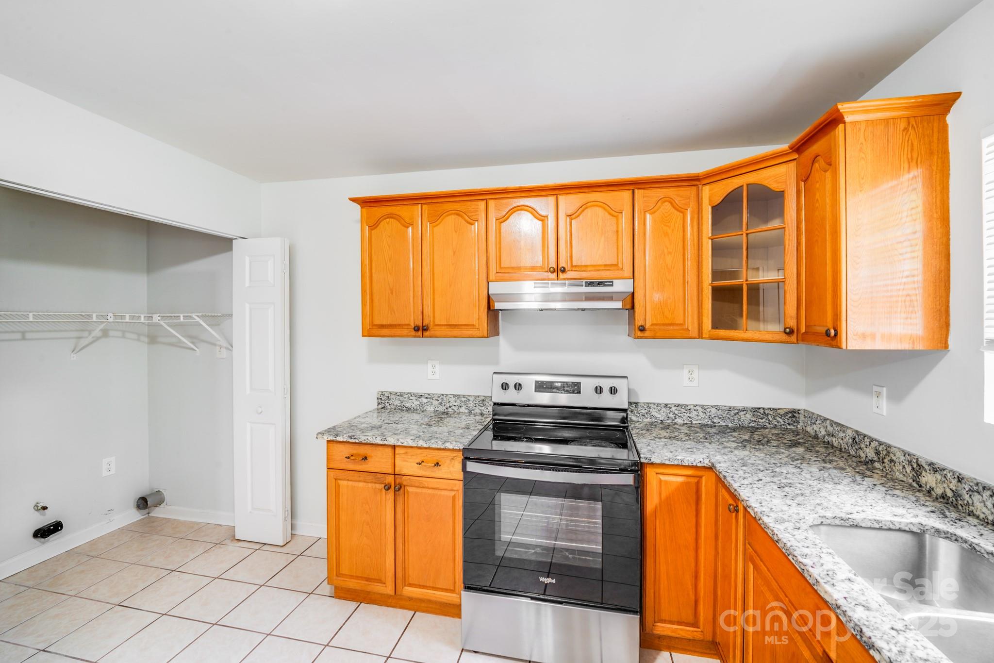 8905 Moores Chapel Road Charlotte, NC 28214 - Photo 10 of 22 a kitchen with granite countertop stainless steel appliances a stove sink and cabinets