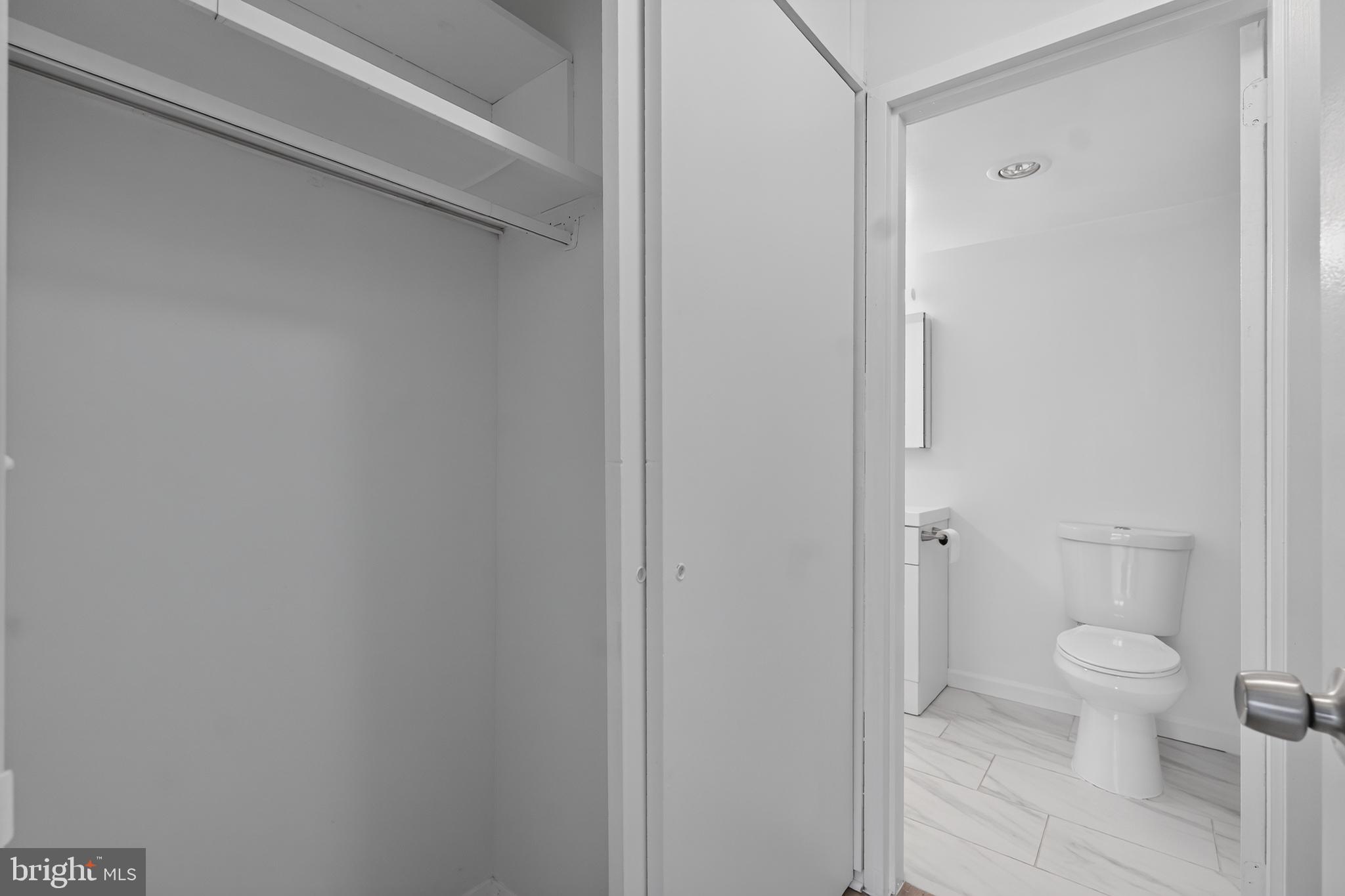 5225 Pooks Hill Road, Unit 1302N Bethesda, MD 20814 - Photo 18 of 19 a bathroom with a granite countertop toilet and a sink