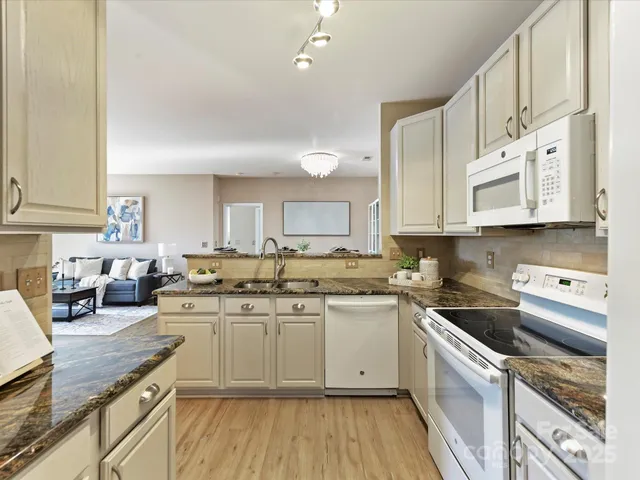 a kitchen with a sink a stove and cabinets