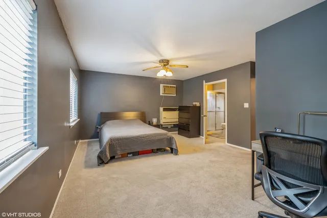 a bedroom with a bed a table and chair