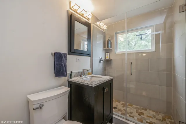 a bathroom with a sink toilet and shower