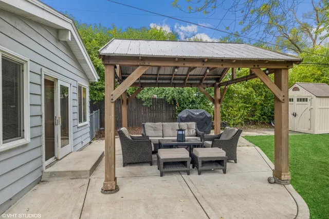 a view of a patio with table and chairs under an umbrella