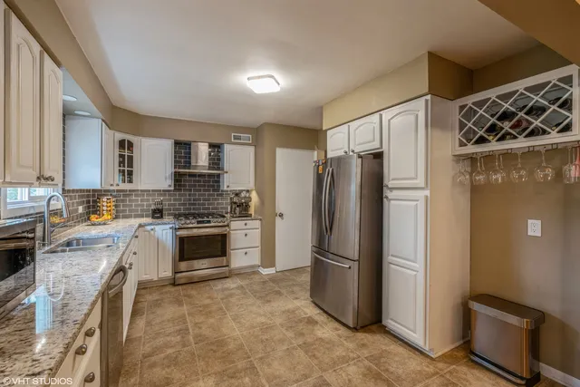a kitchen with stainless steel appliances a refrigerator a stove a sink and dishwasher