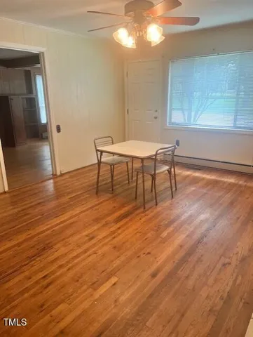 a view of a room with wooden floor and furniture