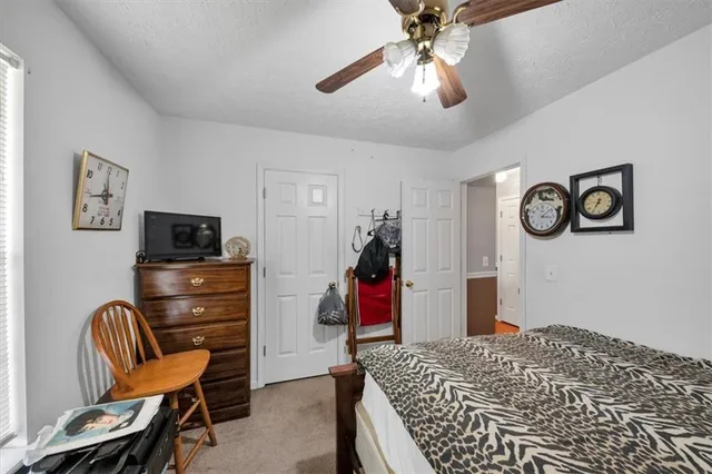 a bedroom with a bed and a television