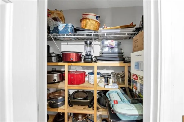 a room with stainless steel appliances and wooden floor