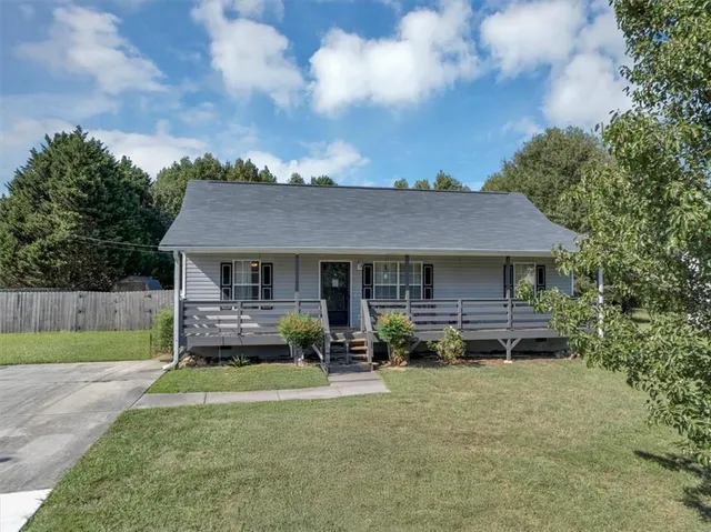 a front view of a house with garden