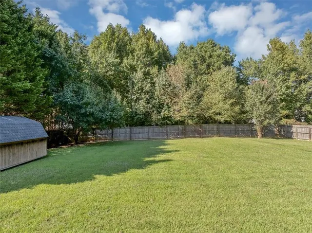 an aerial view of a house with a yard basket ball court and outdoor seating