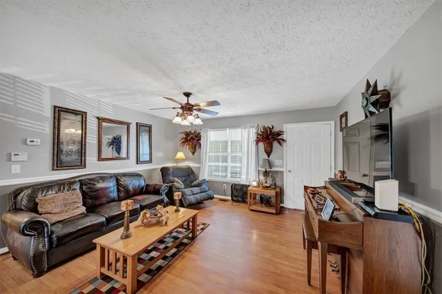 a living room with furniture and wooden floor