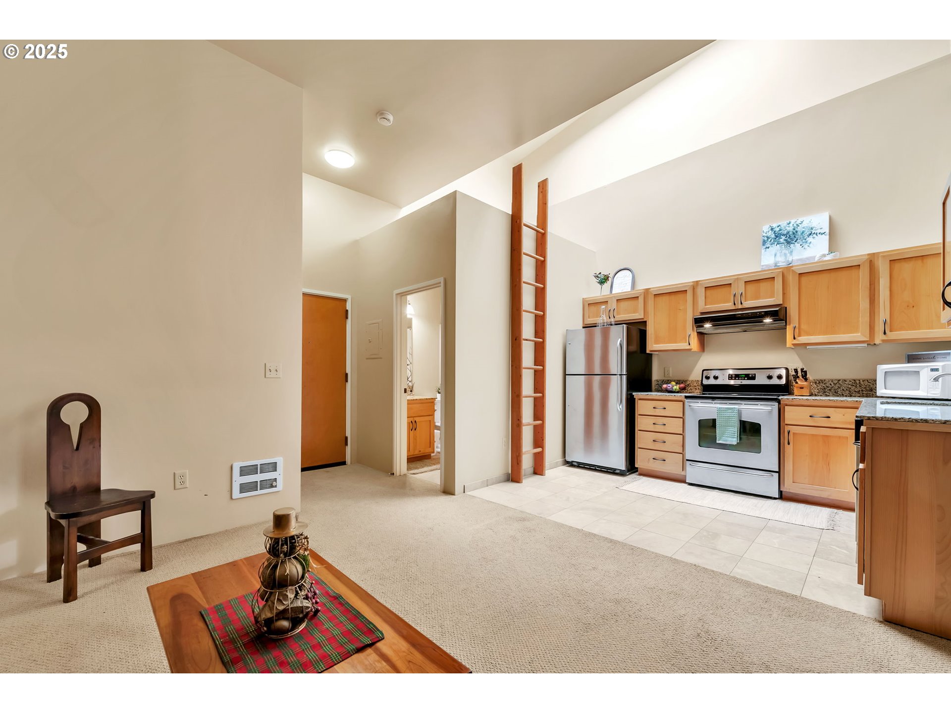 650 West 12th Avenue, Unit 211 Eugene, OR 97402 - Photo 12 of 39 a open kitchen with stainless steel appliances kitchen island granite countertop a stove and a refrigerator
