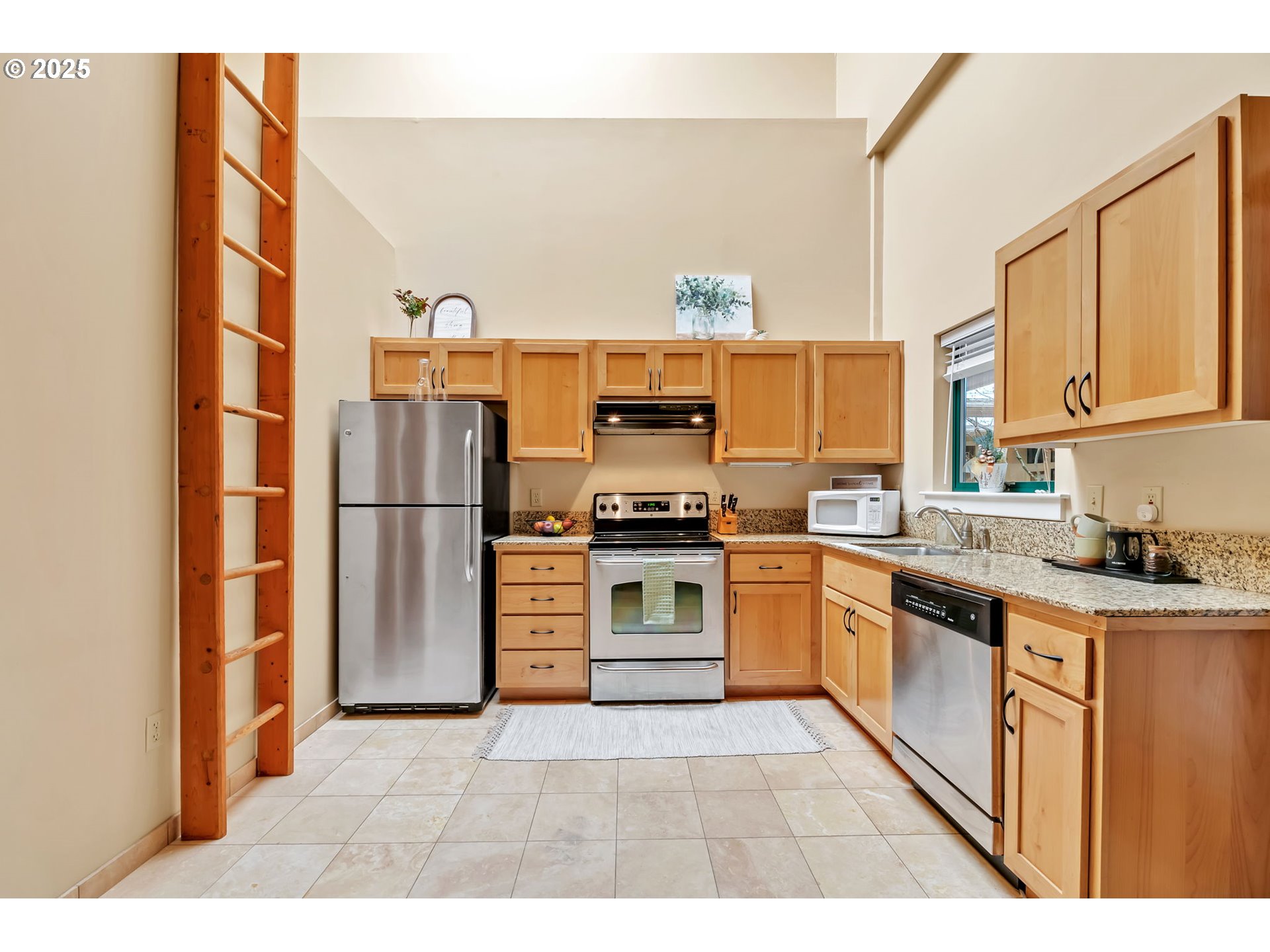 650 West 12th Avenue, Unit 211 Eugene, OR 97402 - Photo 14 of 39 a kitchen with stainless steel appliances granite countertop a refrigerator and a stove top oven