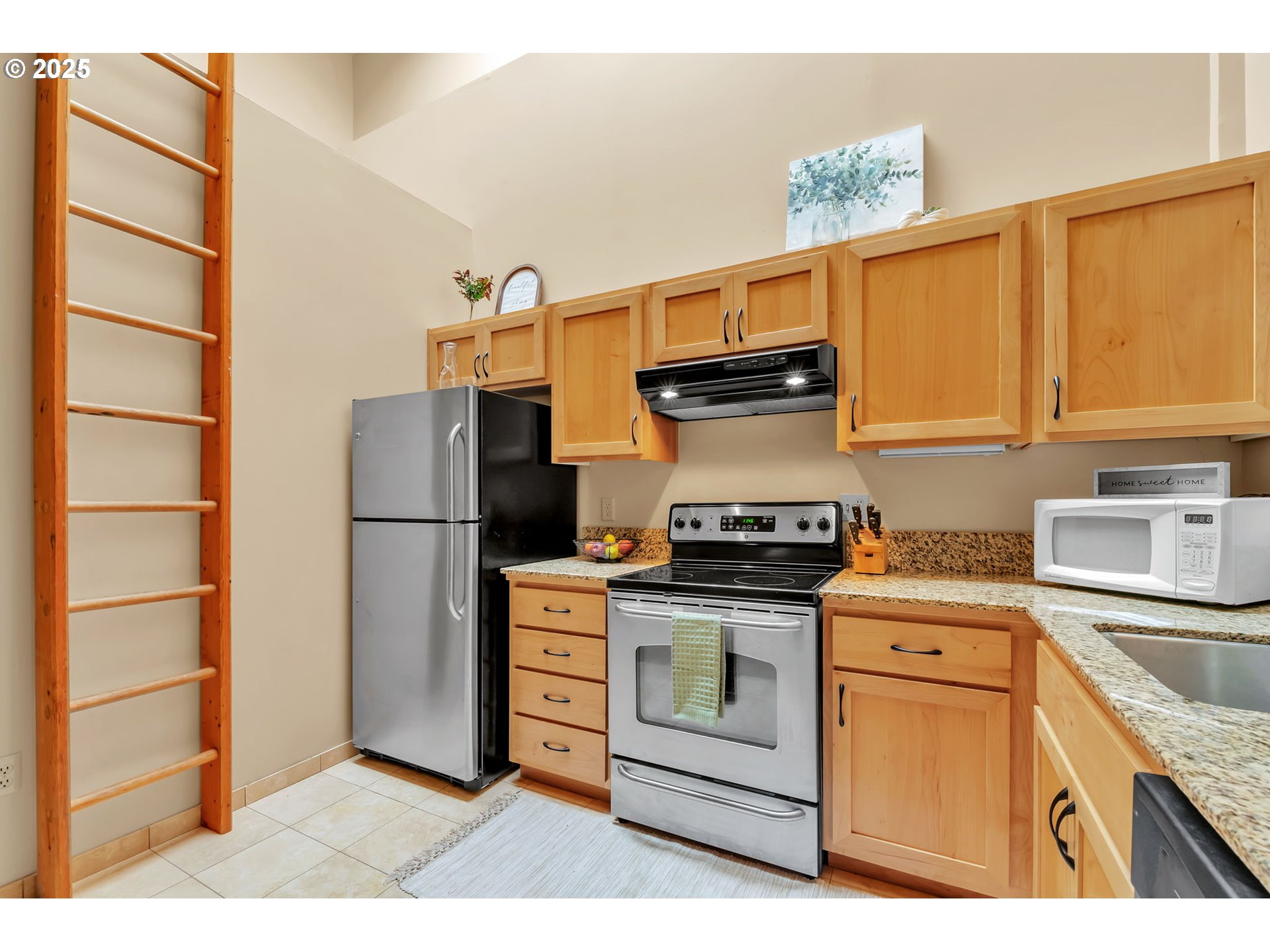 650 West 12th Avenue, Unit 211 Eugene, OR 97402 - Photo 15 of 39 a kitchen with a stove top oven cabinets and stainless steel appliances