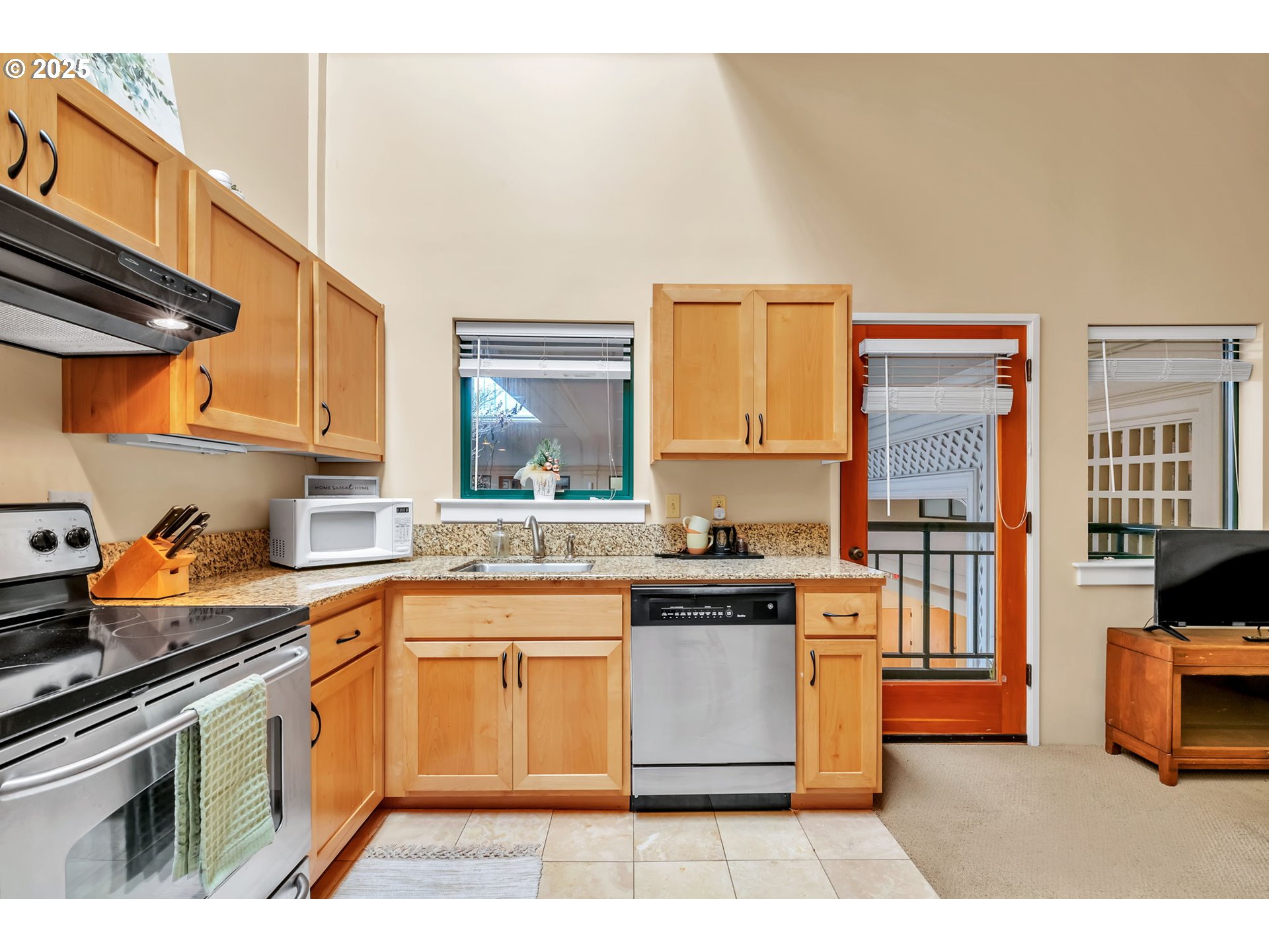 650 West 12th Avenue, Unit 211 Eugene, OR 97402 - Photo 2 of 39 a kitchen with stainless steel appliances granite countertop a stove a sink and a microwave
