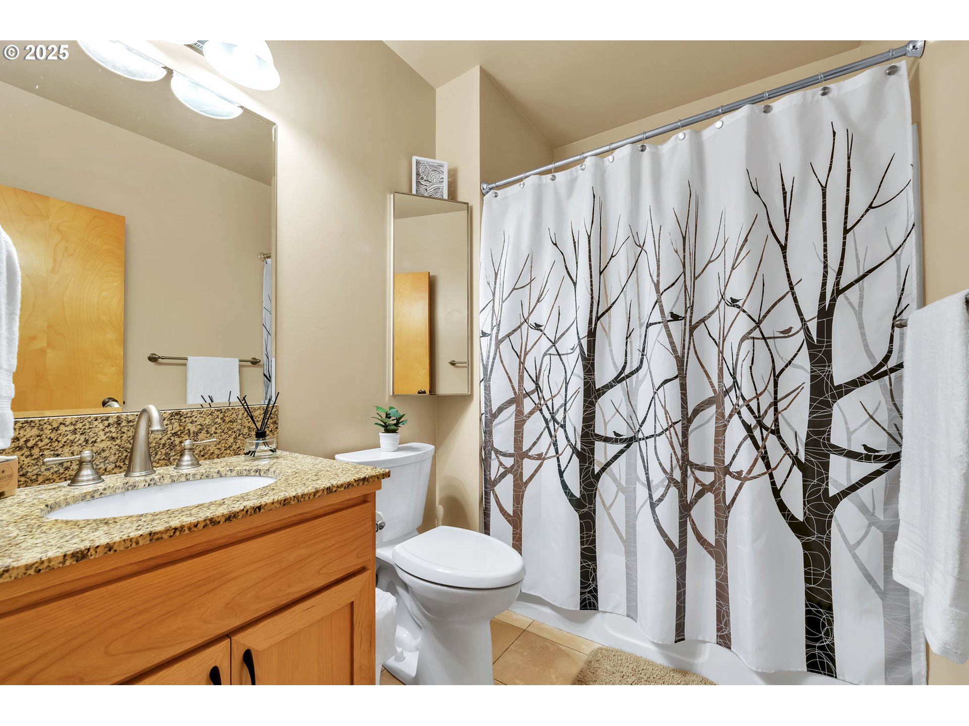 650 West 12th Avenue, Unit 211 Eugene, OR 97402 - Photo 3 of 39 a bathroom with a toilet sink and mirror