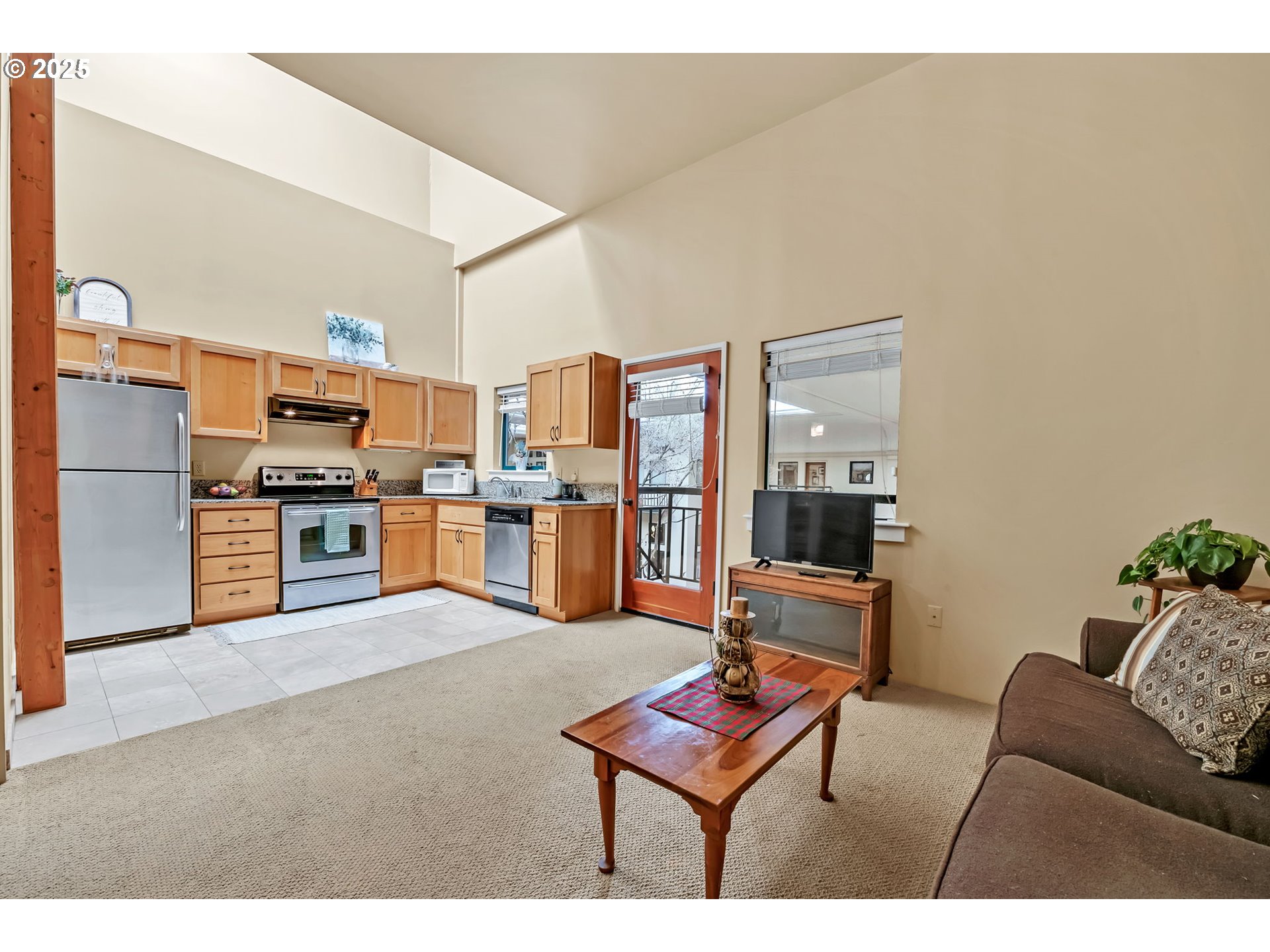 650 West 12th Avenue, Unit 211 Eugene, OR 97402 - Photo 10 of 39 a living room with furniture and kitchen view