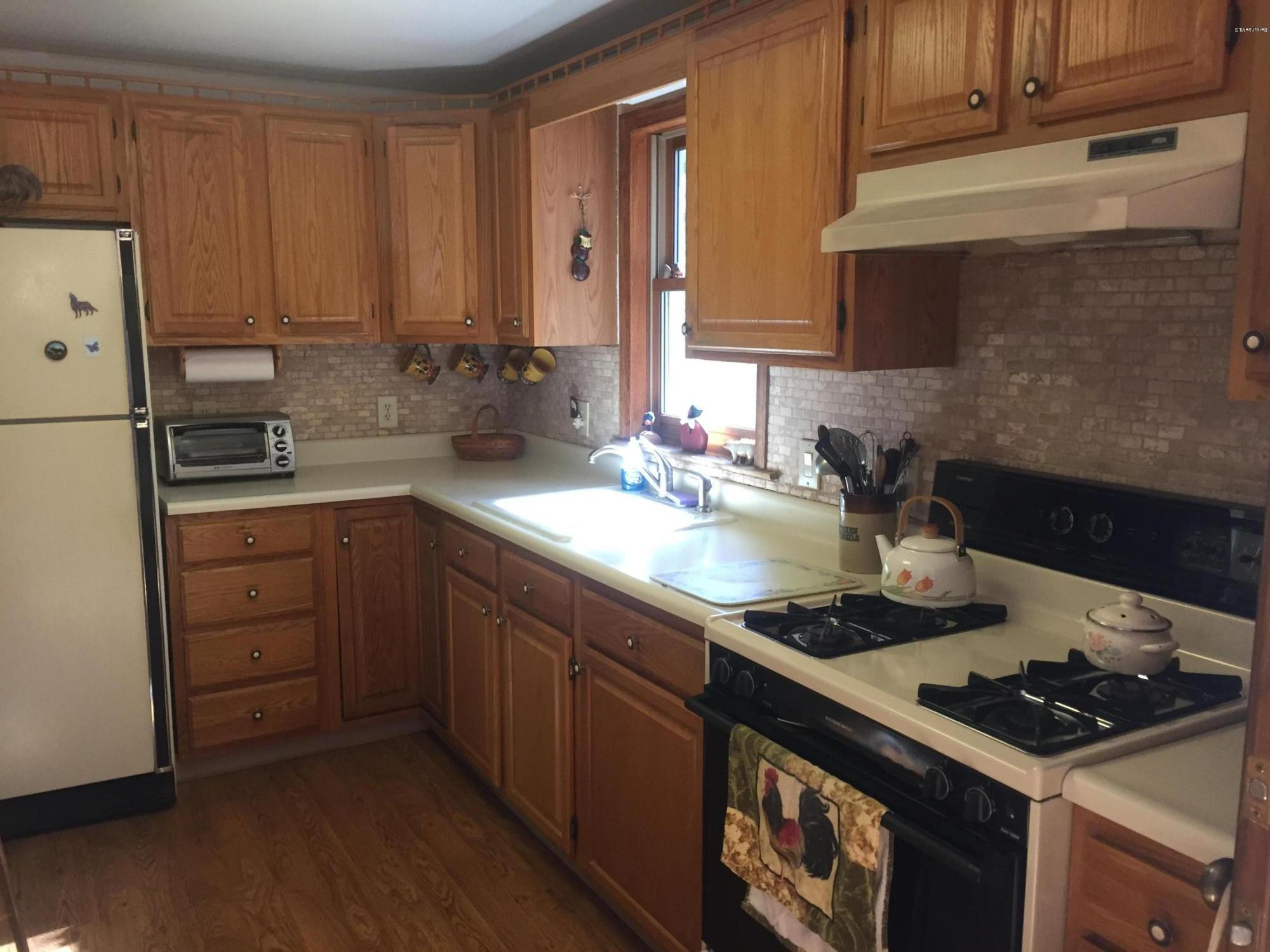 117 Clark Wright Road Middlefield, MA 01050 - Photo 11 of 22 a kitchen with a sink stove and cabinets