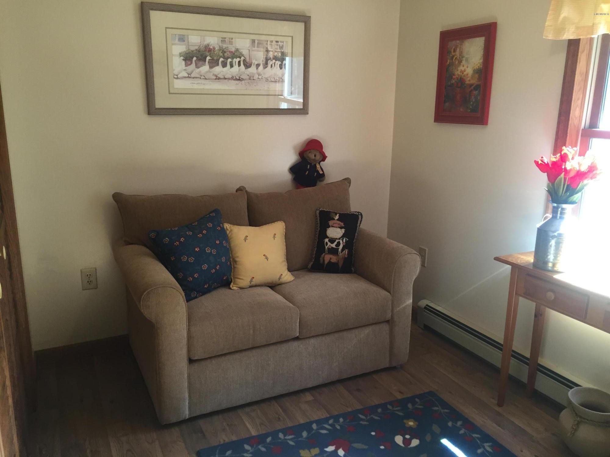 117 Clark Wright Road Middlefield, MA 01050 - Photo 17 of 22 a living room with furniture and flowers