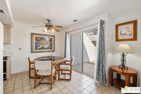 a dining room with furniture and window