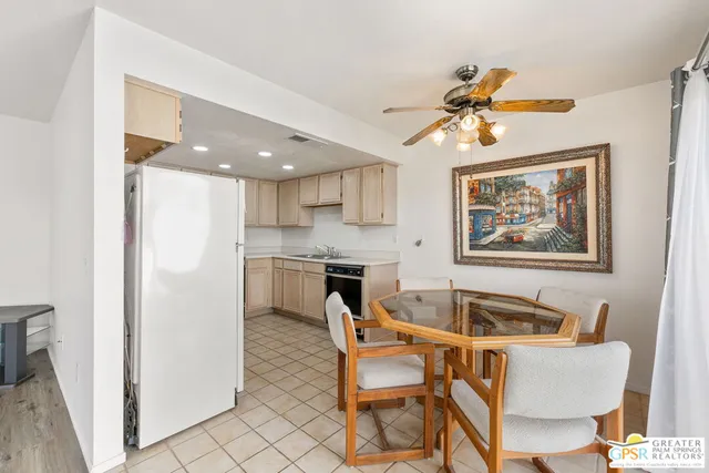 a living room with stainless steel appliances furniture and a chandelier