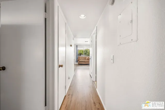 a view of a hallway with wooden floor