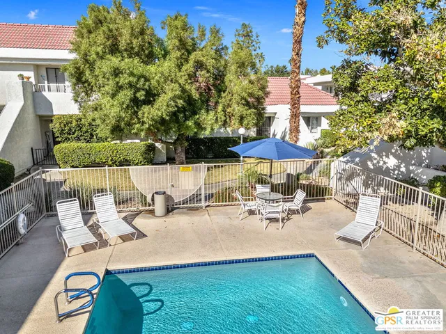 a view of a patio with chairs and a table