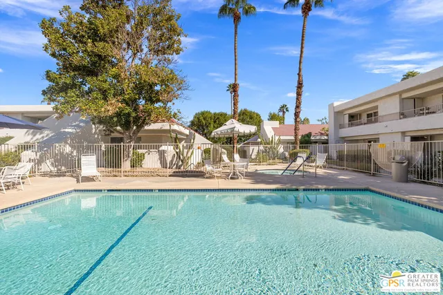 a view of a patio with a table and chairs