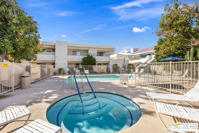a view of a patio with couches table and chairs and potted plants