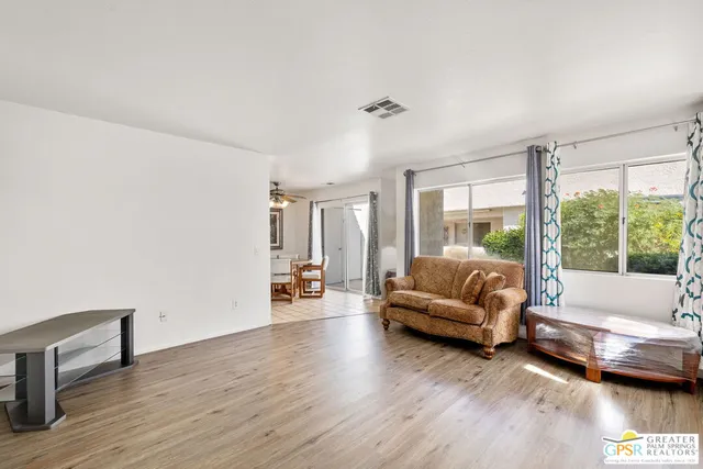 a living room with furniture and a large window