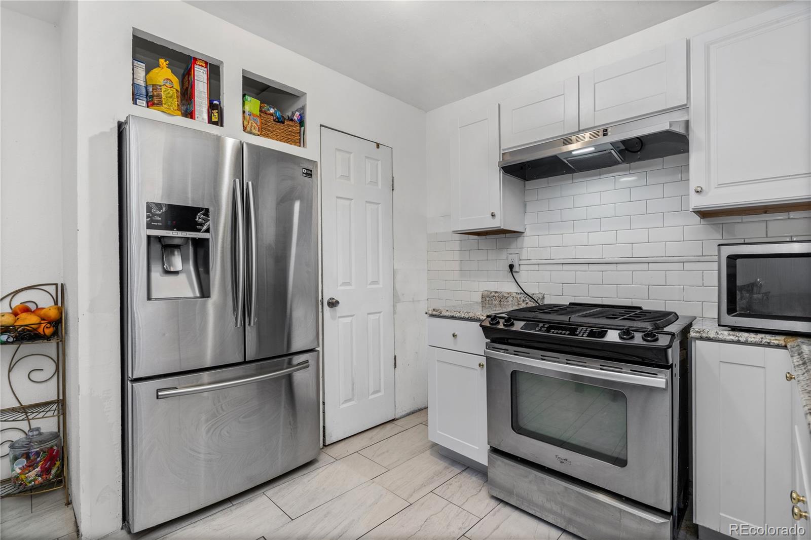505 26th Avenue Greeley, CO 80634 - Photo 5 of 18 a kitchen with stainless steel appliances a stove a refrigerator and a cabinets