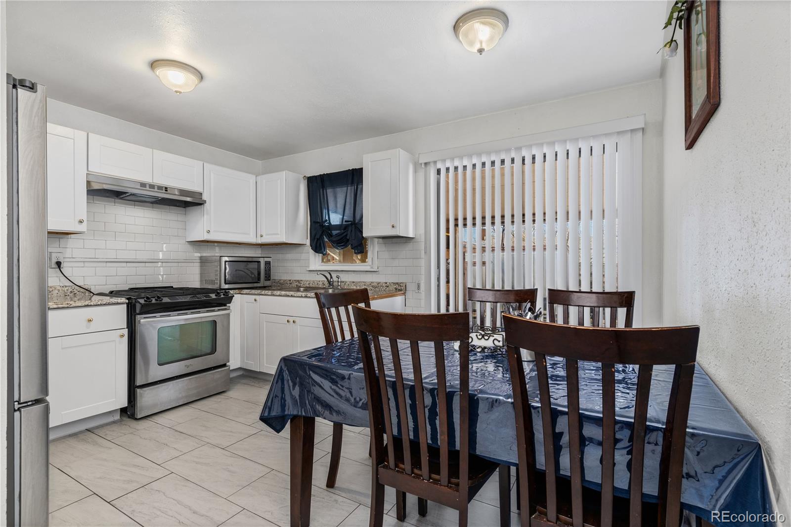 505 26th Avenue Greeley, CO 80634 - Photo 6 of 18 a kitchen with a table chairs stove and cabinets