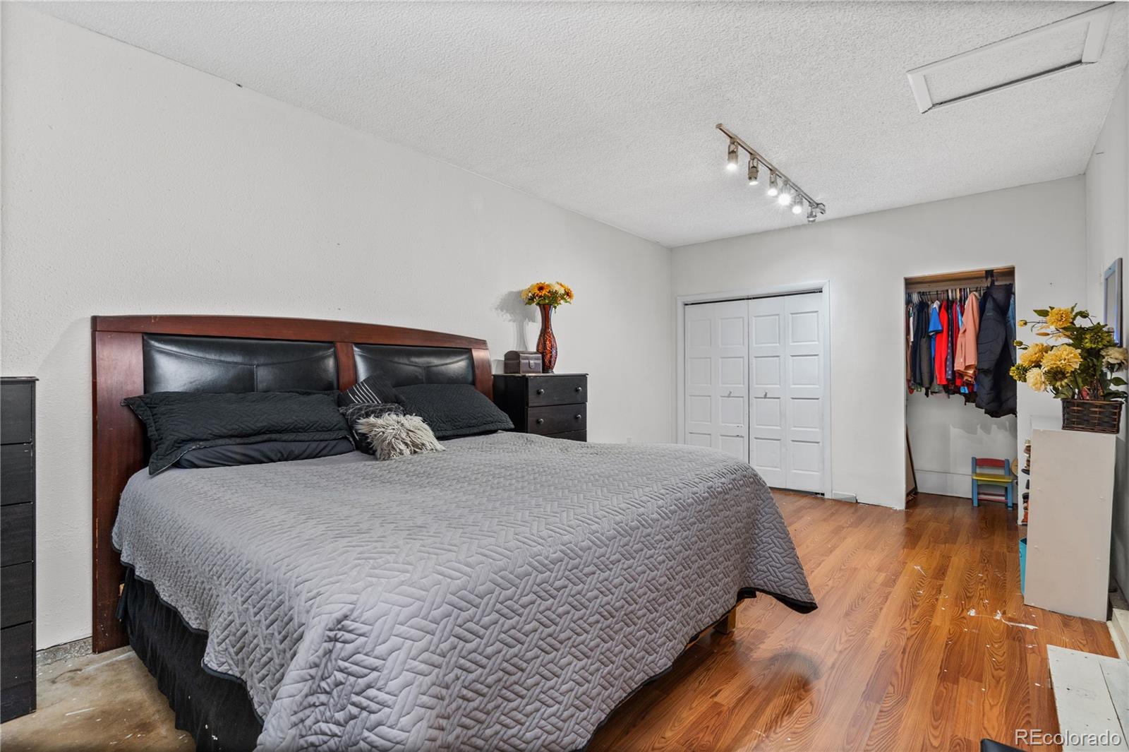 505 26th Avenue Greeley, CO 80634 - Photo 8 of 18 a bedroom with a bed and wooden floor