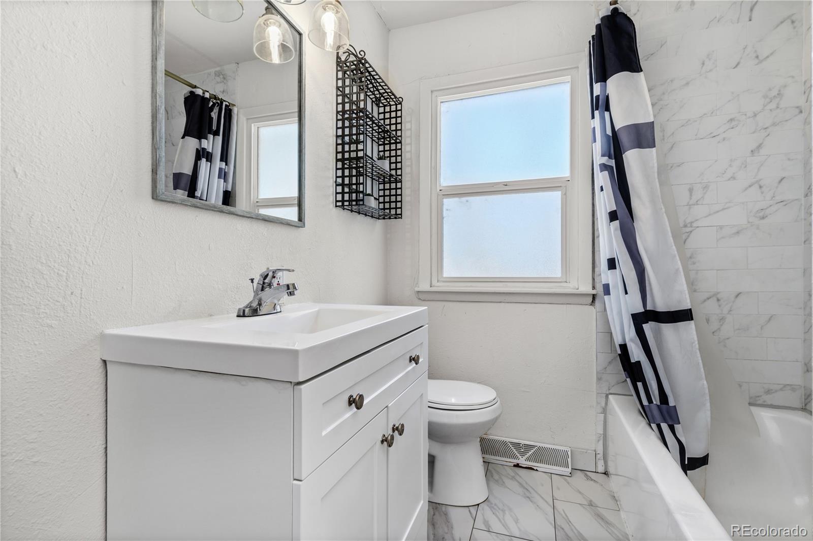 505 26th Avenue Greeley, CO 80634 - Photo 9 of 18 a bathroom with a sink toilet and mirror