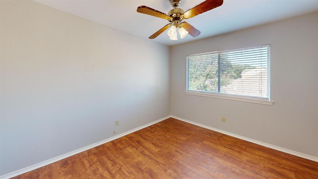 7913 Rice Drive Rowlett, TX 75088 - Photo 15 of 25 Interior room featuring wood-finish flooring, a ceiling fan with light fixture, and a window with horizontal blinds