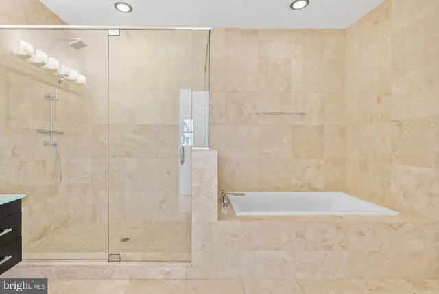 a bathroom with a shower sink vanity and mirror