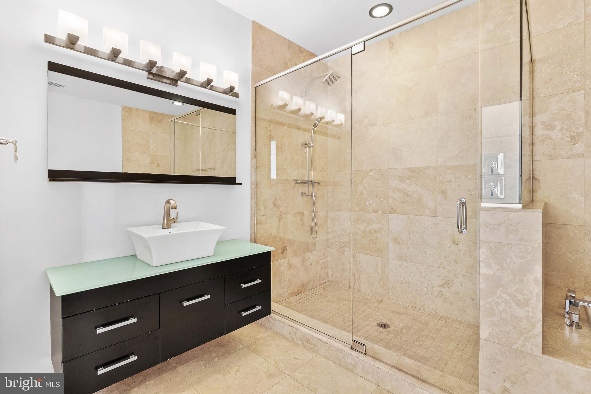 2103 East Susquehanna Avenue Philadelphia, PA 19125 - Photo 15 of 31 a bathroom with a shower sink vanity and mirror