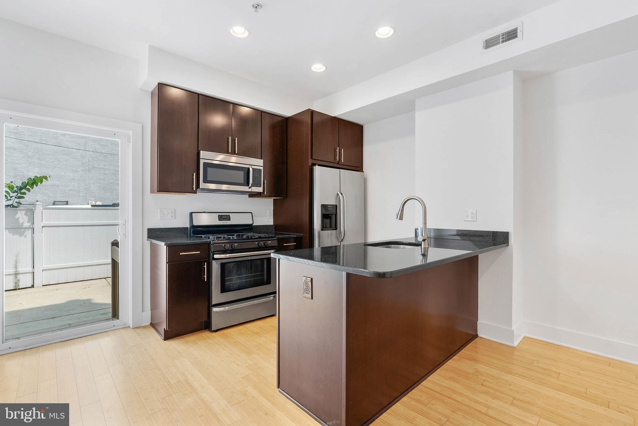 2103 East Susquehanna Avenue Philadelphia, PA 19125 - Photo 2 of 31 a kitchen with stainless steel appliances granite countertop a stove a sink and a refrigerator