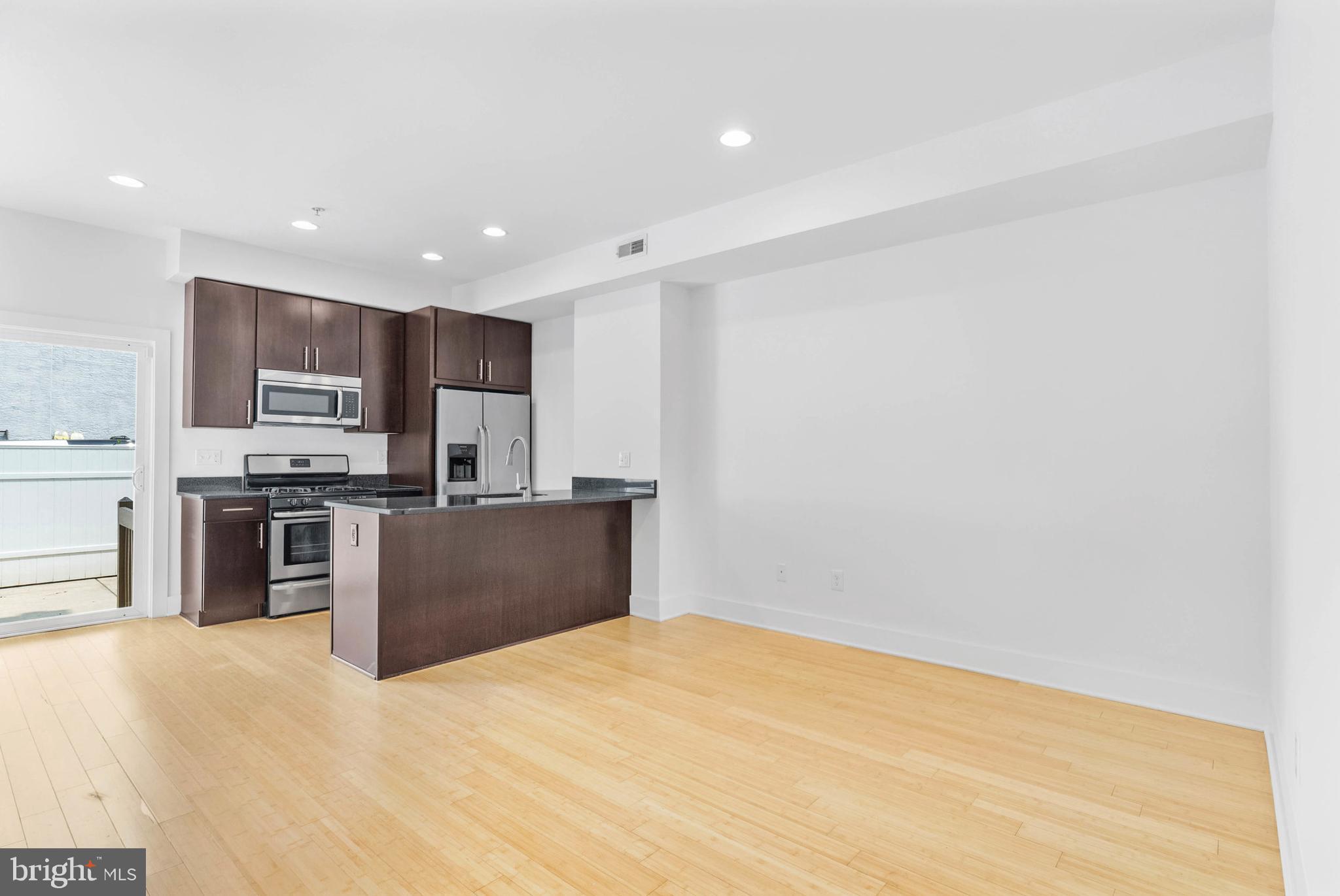 2103 East Susquehanna Avenue Philadelphia, PA 19125 - Photo 5 of 31 a kitchen with stainless steel appliances granite countertop a refrigerator and a sink