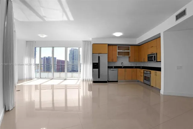 a large kitchen with a large window