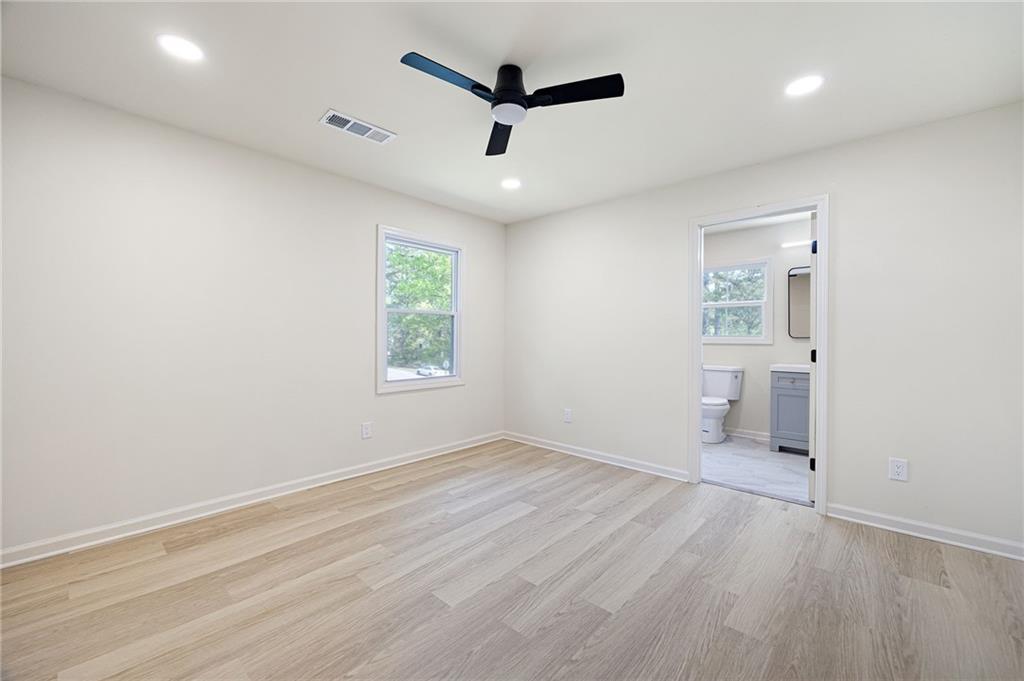 4289 Kimball Road Southwest Atlanta, GA 30331 - Photo 17 of 20 an empty room with windows and a ceiling fan