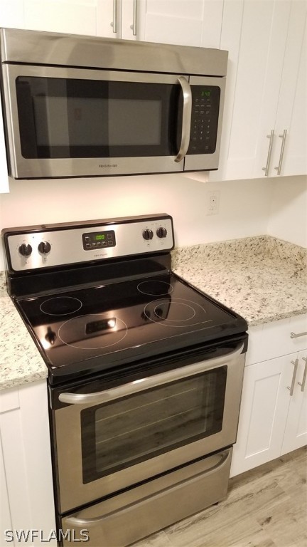 5313 Treetops Drive, Unit 202 Naples, FL 34113 - Photo 11 of 22 a stove top oven sitting inside of a kitchen