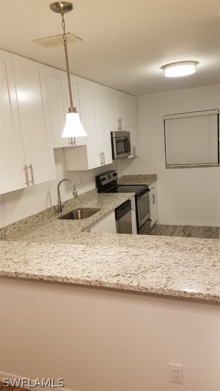 5313 Treetops Drive, Unit 202 Naples, FL 34113 - Photo 12 of 22 a kitchen with stainless steel appliances granite countertop a sink a stove counter space and cabinets