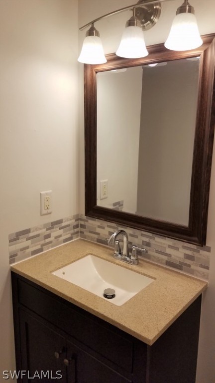 5313 Treetops Drive, Unit 202 Naples, FL 34113 - Photo 15 of 22 a bathroom with a sink and a mirror