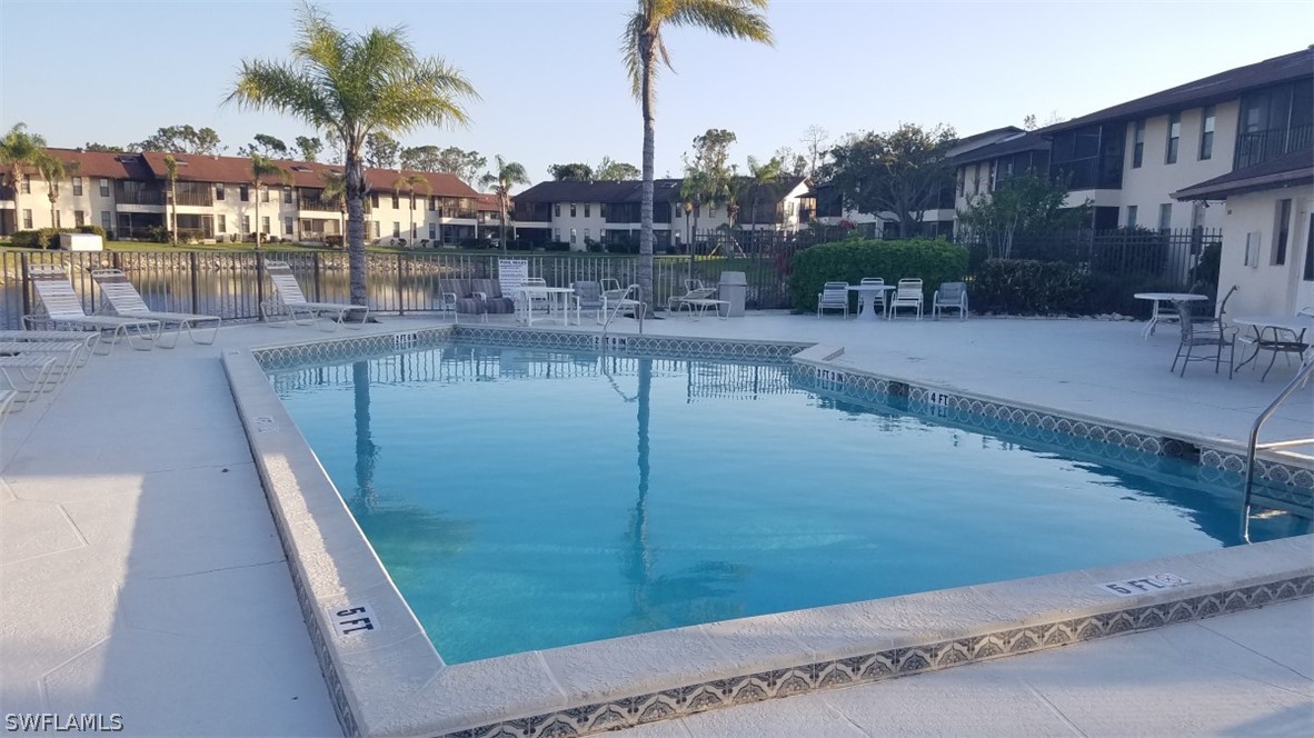 5313 Treetops Drive, Unit 202 Naples, FL 34113 - Photo 20 of 22 a view of a swimming pool with a patio